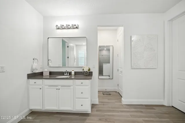 a bedroom with a white bed and a couch