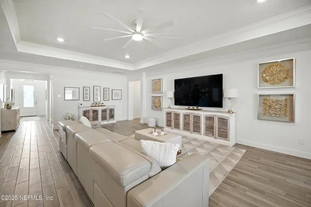 a living room with furniture and kitchen view