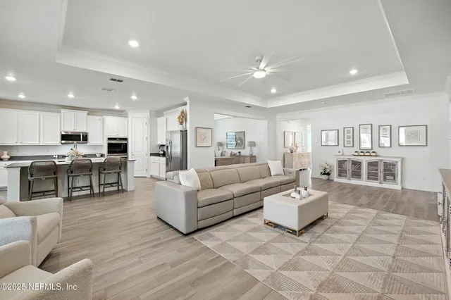 a view of a livingroom with furniture and hardwood floor