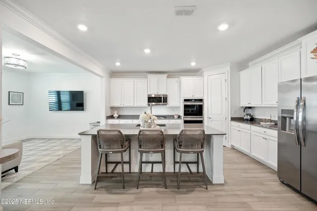 a kitchen with sink refrigerator and window