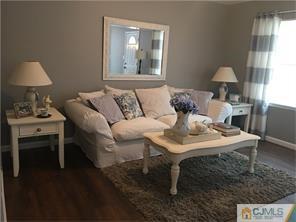 34 Colton Road Edison, NJ 08817 - Photo 1 of 5 a living room with a couch and a table