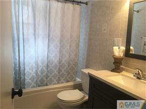 34 Colton Road Edison, NJ 08817 - Photo 2 of 5 a bathroom with a granite countertop bathtub sink and toilet