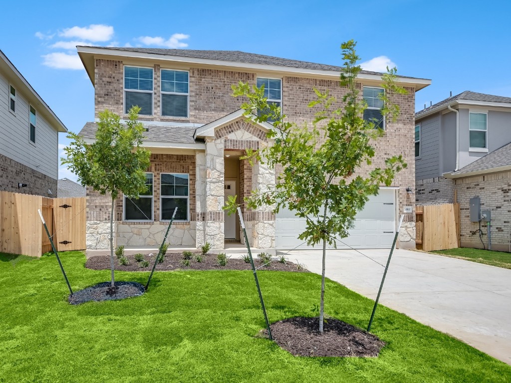 a view of a house with a yard and sitting area