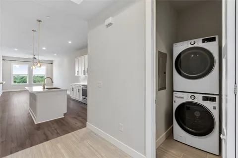 a view of a hallway with wooden floor and a livingroom
