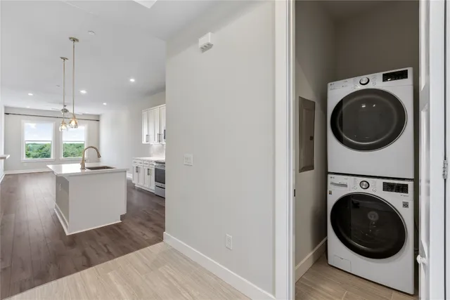 a view of a hallway with wooden floor and a livingroom