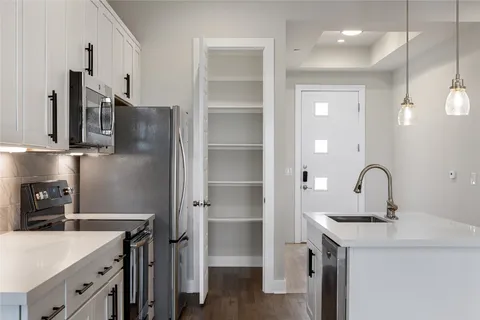 a view of a kitchen with wooden floor and a window