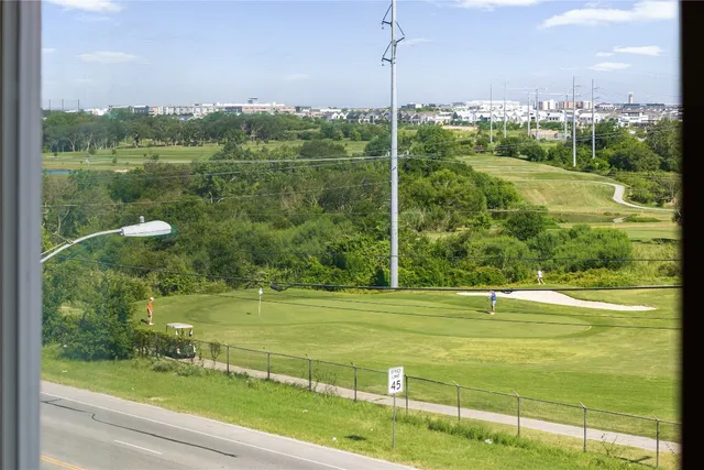 an empty room with a window and wooden floor