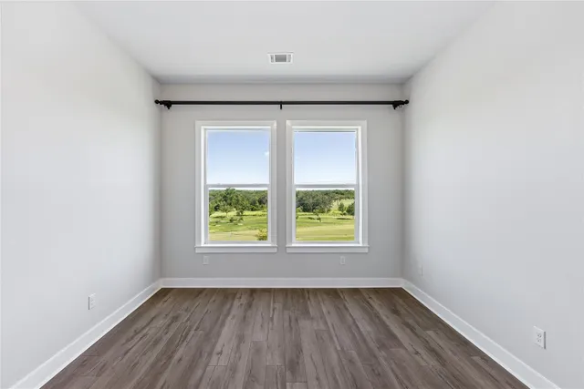 a kitchen with kitchen island white cabinets and stainless steel appliances