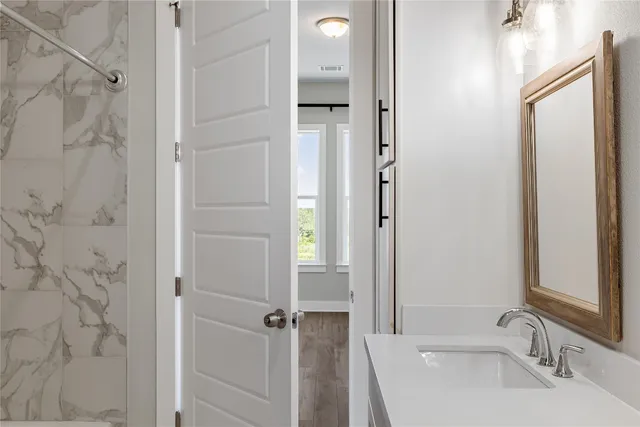 a bathroom with a sink and a mirror