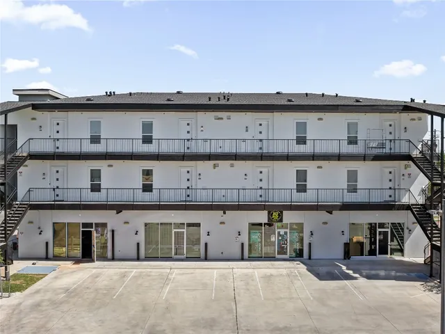 a front view of a building with a swimming pool