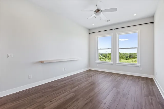 a kitchen with a refrigerator a sink and wooden floor