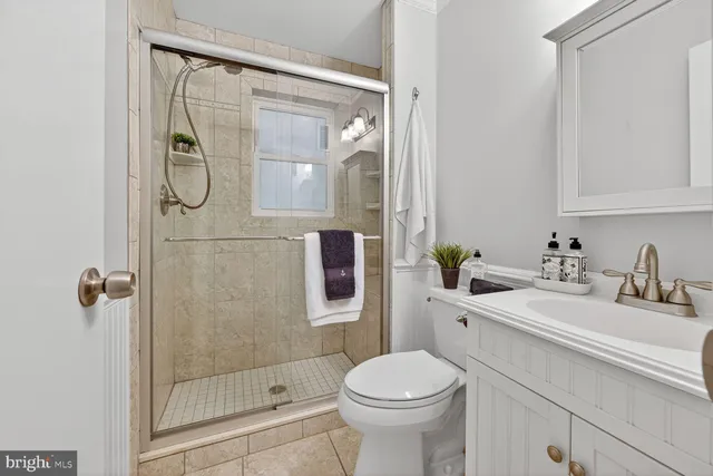 a bedroom with a bed and dresser with mirror