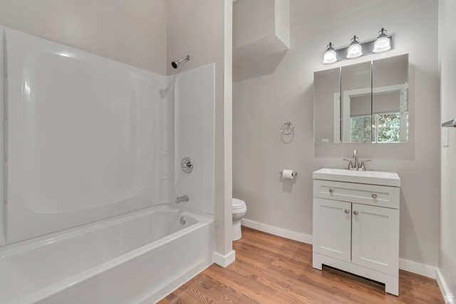 2154 Wasatch Boulevard Sandy, UT 84092 - Photo 49 of 55 Bathroom featuring vanity, light wood-style flooring, and bathing tub / shower combination