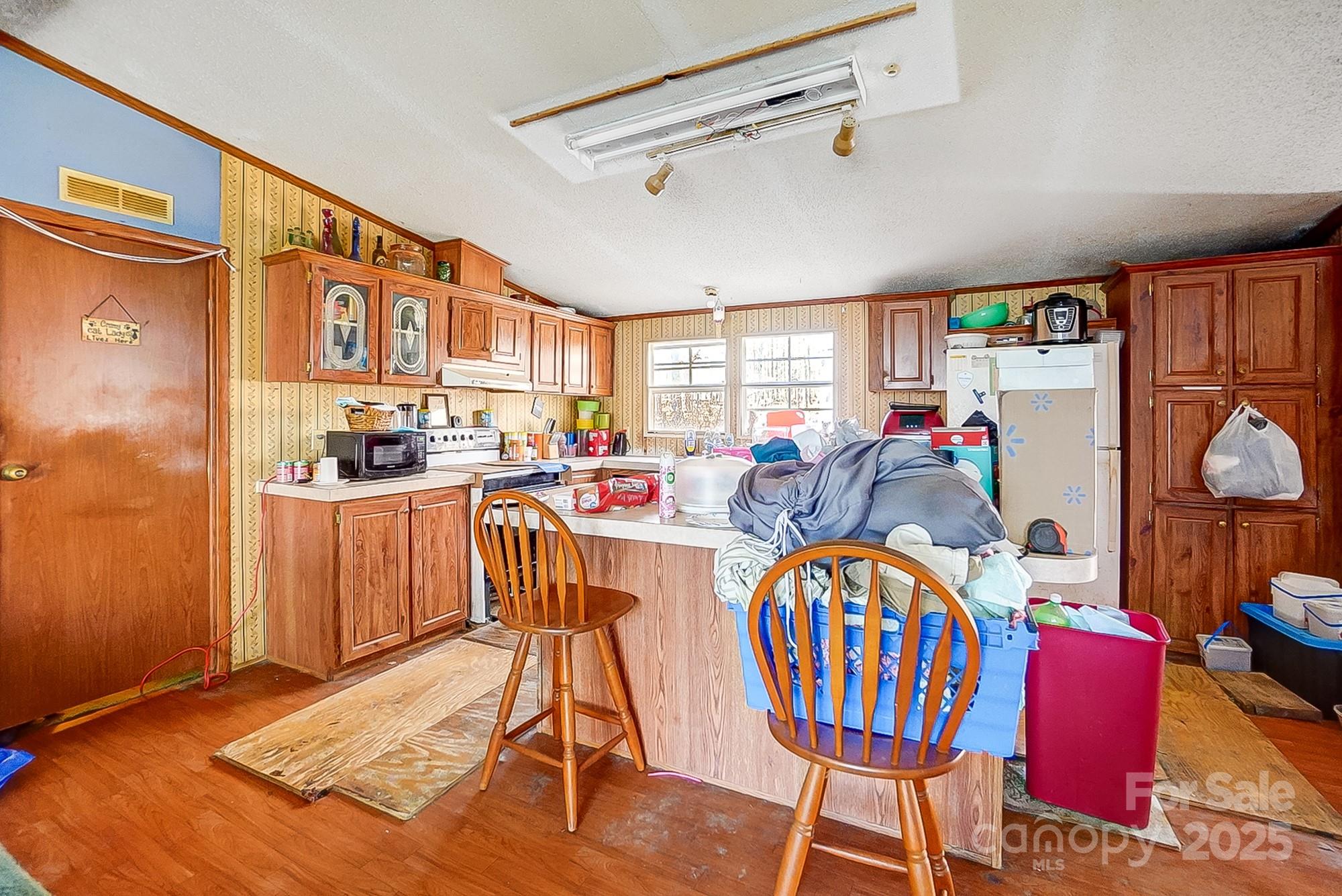 2166 Hough Road Lancaster, SC 29720 - Photo 21 of 23 a dining room with furniture a rug a flat screen tv and a large window