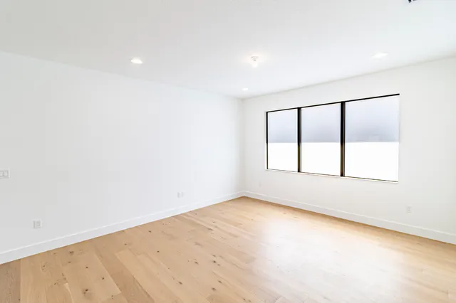 a front view of house with yard and trees in the background