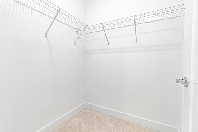 a front view of a house with a garden and palm trees