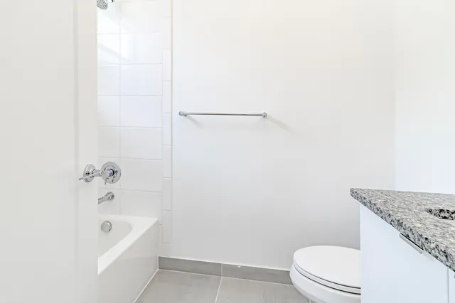 a front view of a house with a garden and plants