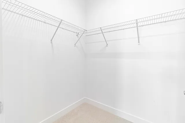 a living room with patio furniture and a large window