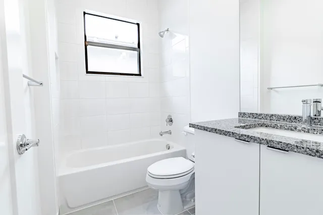 a view of a house with a big yard and a large tree