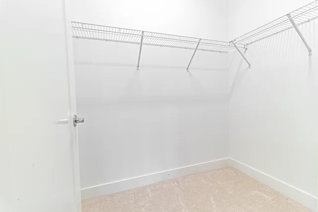 a view of staircase with white walls and a window