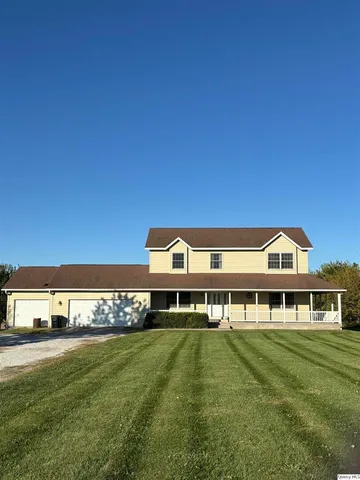 a front view of a house with a big yard
