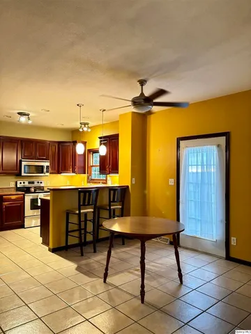 a living room with kitchen furniture and a table