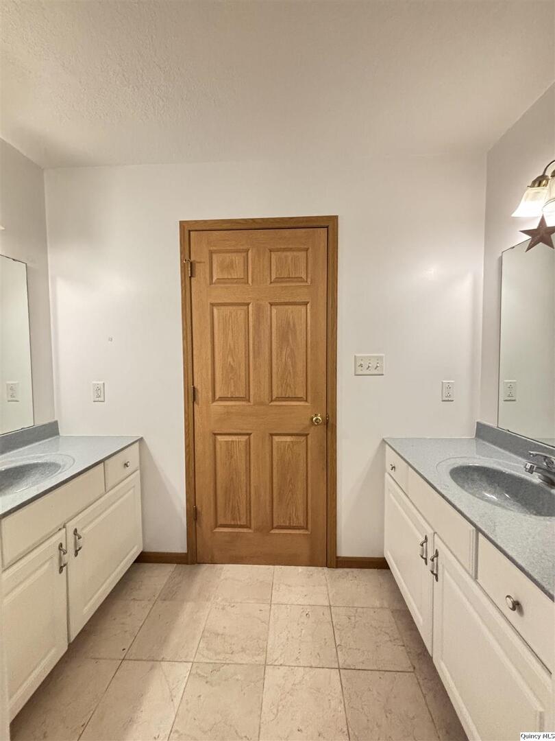 1848 North Co Road 1700 Carthage, IL 62321 - Photo 25 of 33 a spacious bathroom with a granite countertop sink and a mirror