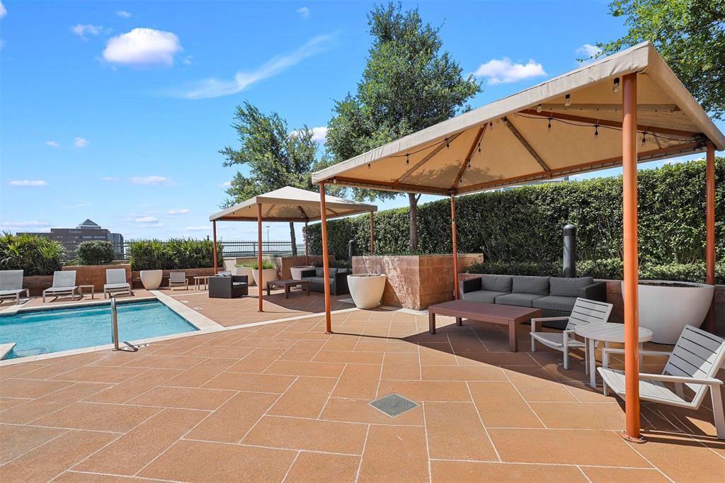 330 Las Colinas Boulevard East, Unit 232 Irving, TX 75039 - Photo 13 of 14 a view of a patio with a table and chairs under an umbrella