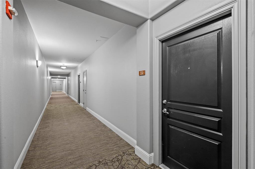 330 Las Colinas Boulevard East, Unit 232 Irving, TX 75039 - Photo 10 of 14 a view of hallway with stairs and a wooden floor