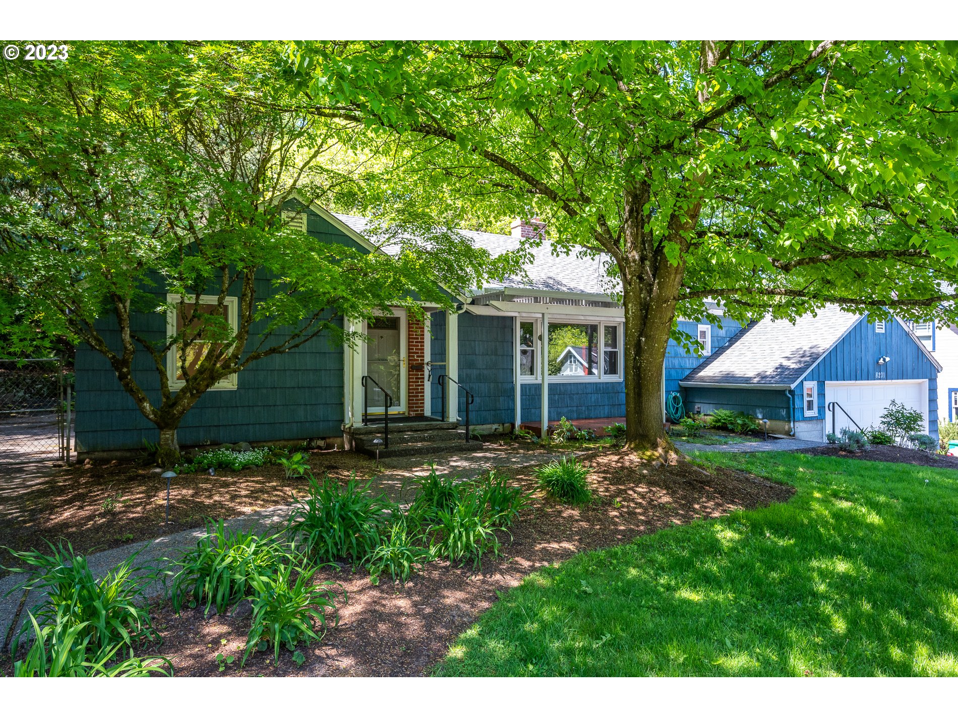 8201 Southwest 41st Avenue Portland, OR 97219 - Photo 1 of 23 a view of a yard in front of a house with large tree