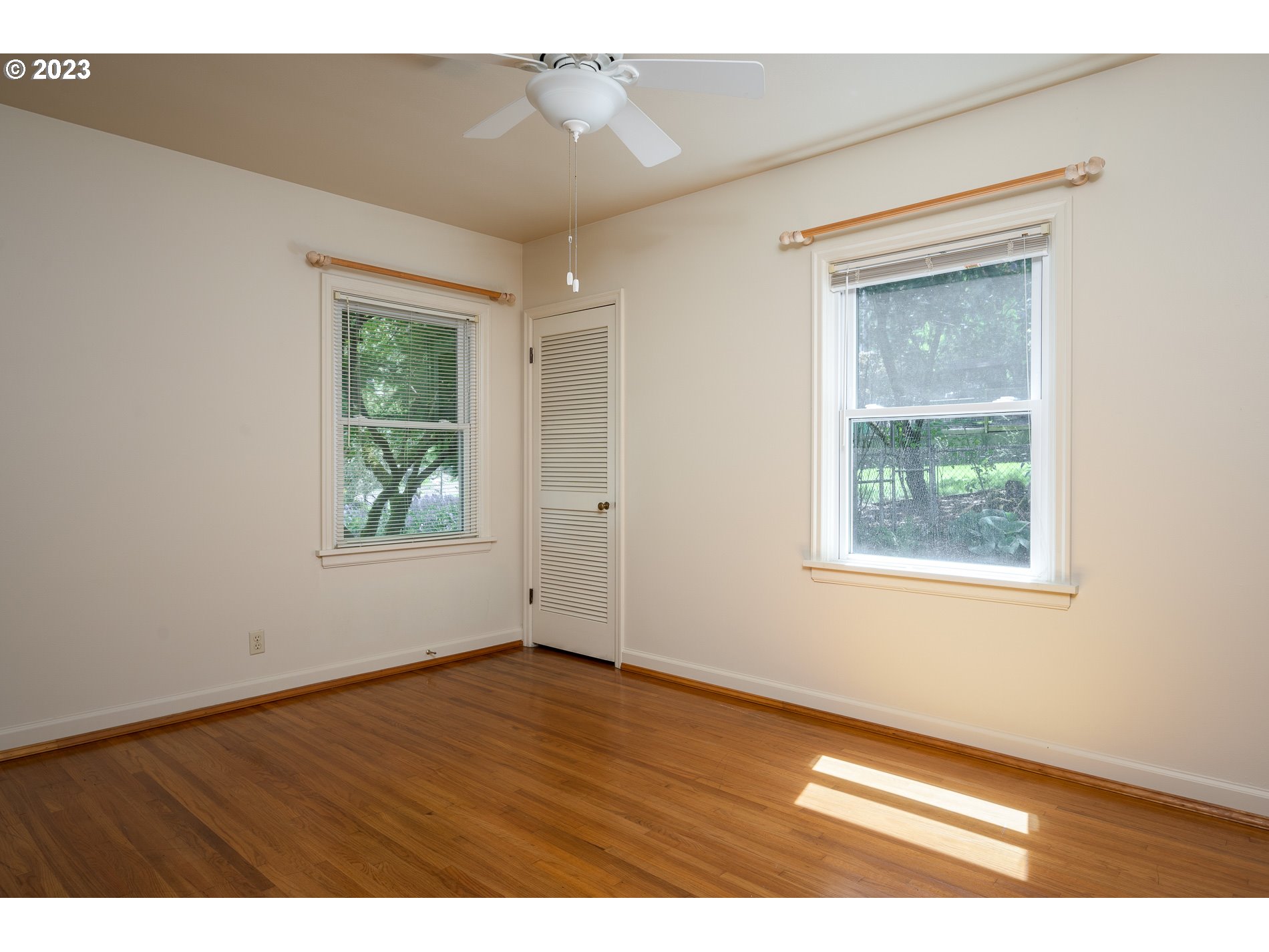 8201 Southwest 41st Avenue Portland, OR 97219 - Photo 11 of 23 a view of an empty room with wooden floor and a window