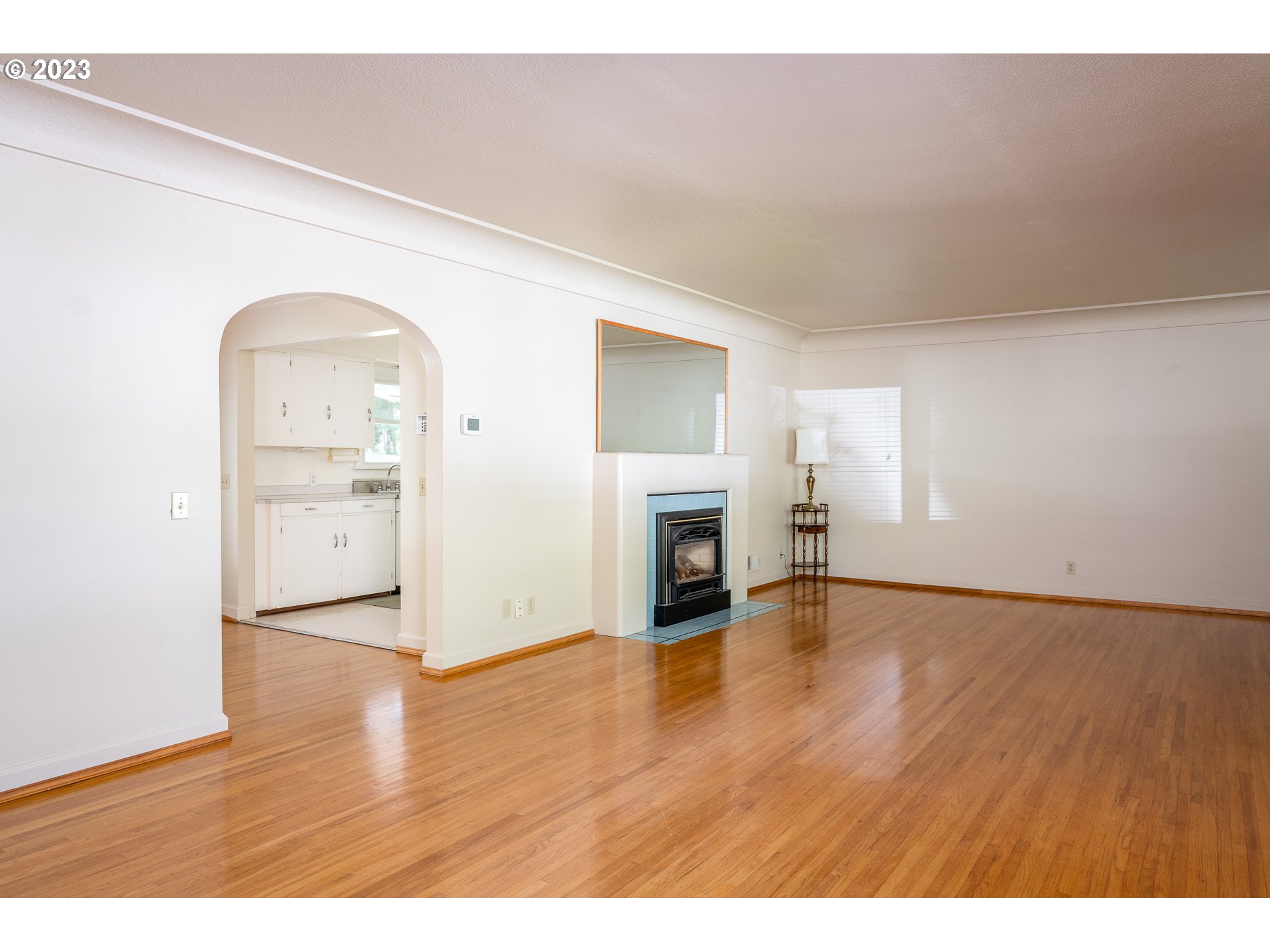 8201 Southwest 41st Avenue Portland, OR 97219 - Photo 3 of 23 a view of empty room with wooden floor and fireplace