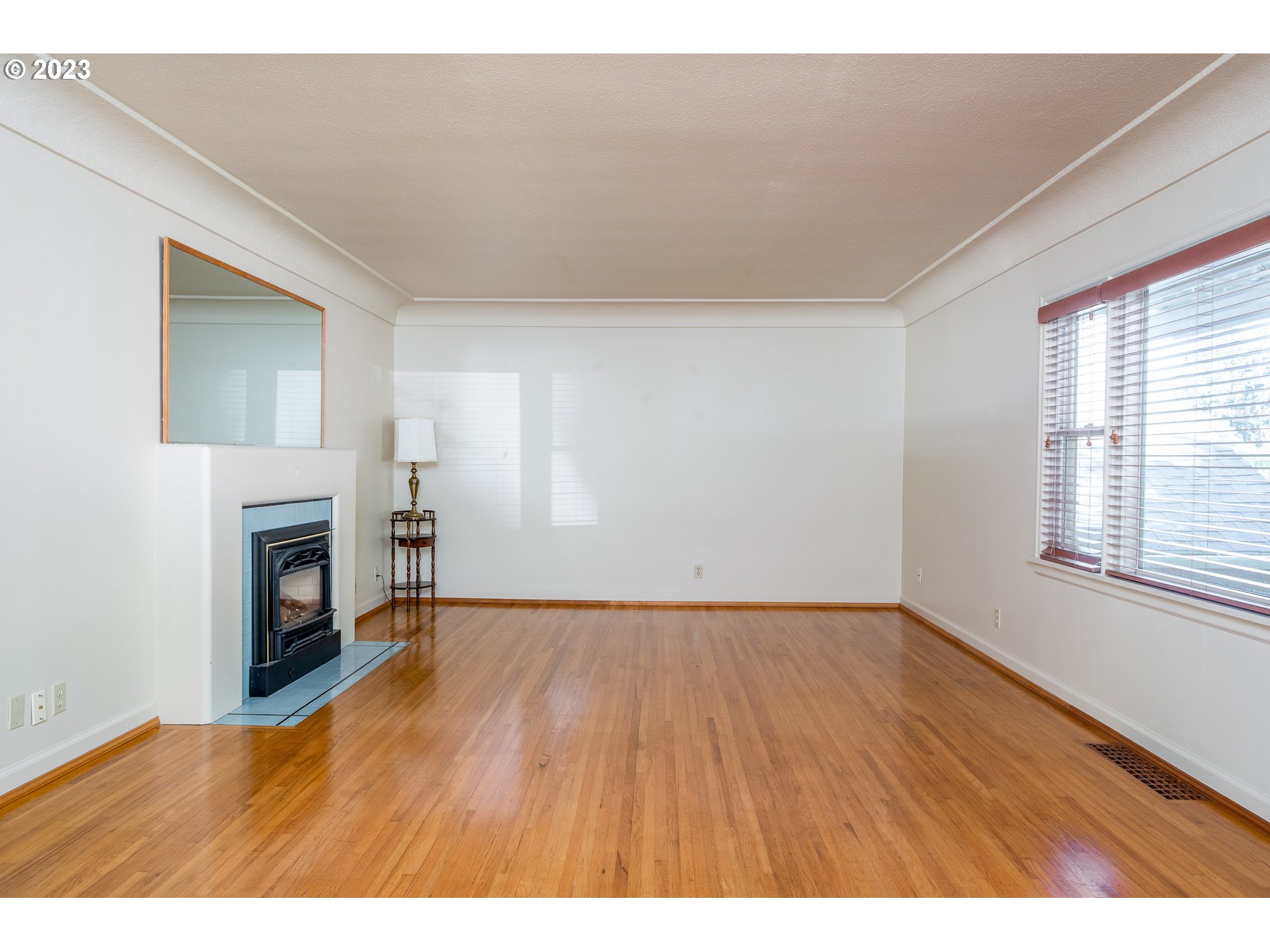 8201 Southwest 41st Avenue Portland, OR 97219 - Photo 4 of 23 a view of an empty room with a fireplace and a window