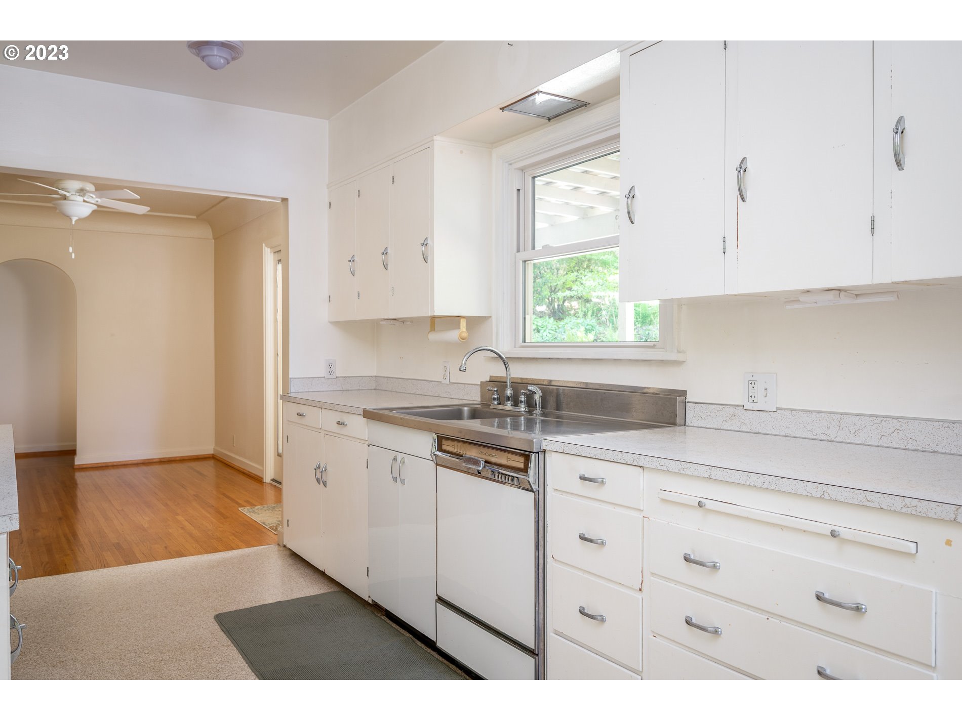 8201 Southwest 41st Avenue Portland, OR 97219 - Photo 10 of 23 a kitchen with granite countertop white cabinets and white appliances