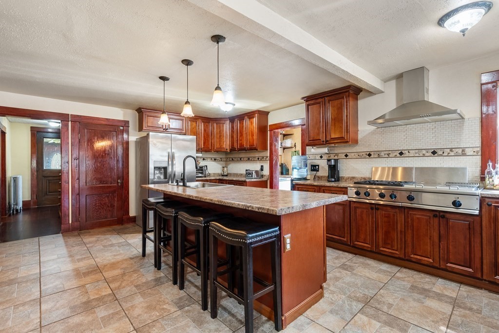 65 NW Road Westfield, MA 01085 - Photo 5 of 29 a kitchen with stainless steel appliances granite countertop a table chairs sink and cabinets
