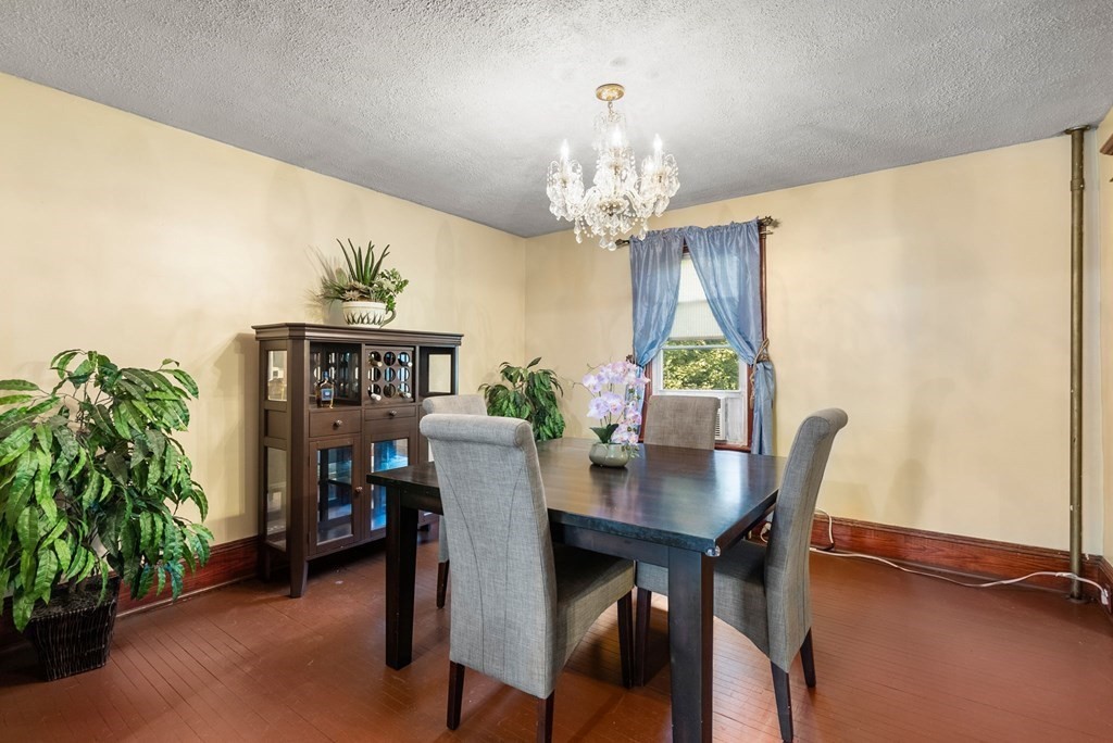 65 NW Road Westfield, MA 01085 - Photo 8 of 29 a view of a dining room with furniture and chandelier