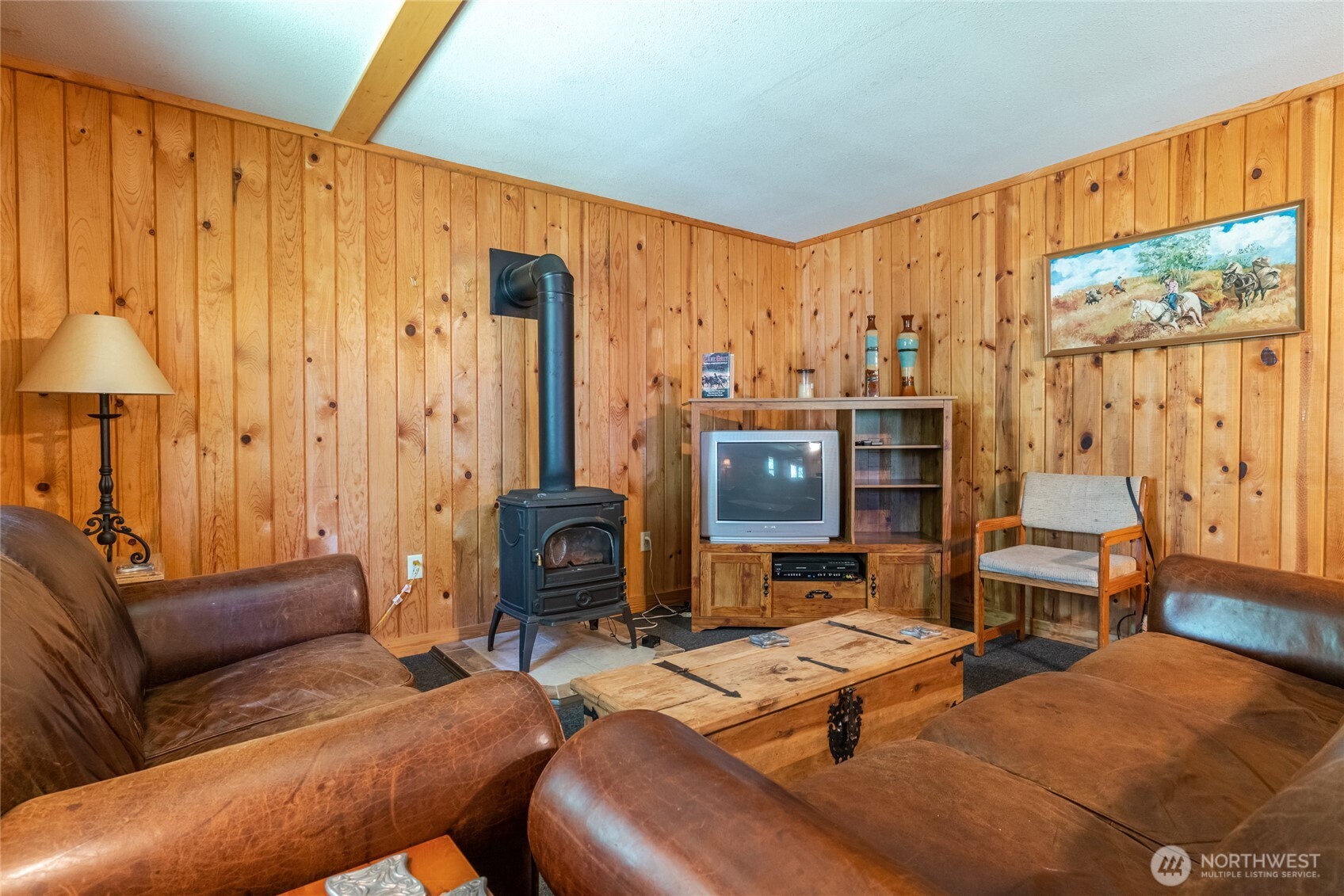 579 Eastside Chewuch Road Winthrop, WA 98862 - Photo 11 of 37 a living room with furniture a large window and a flat screen tv