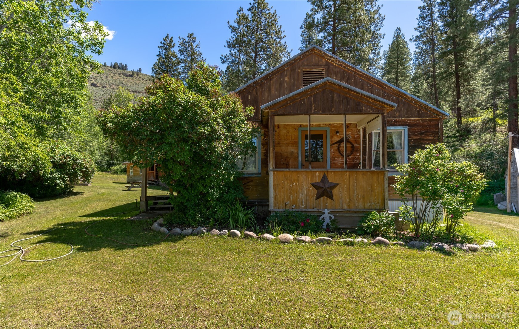579 Eastside Chewuch Road Winthrop, WA 98862 - Photo 16 of 37 a front view of a house with a yard