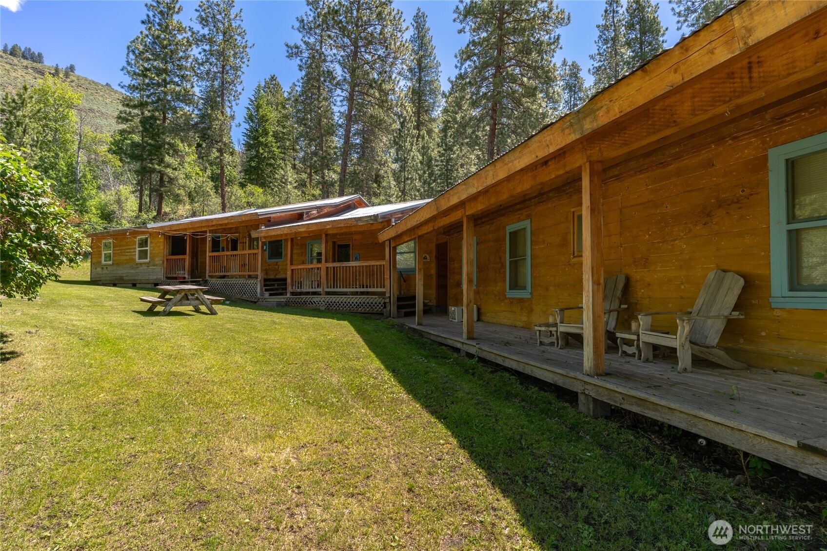 579 Eastside Chewuch Road Winthrop, WA 98862 - Photo 9 of 37 a view of a house with backyard porch and sitting area