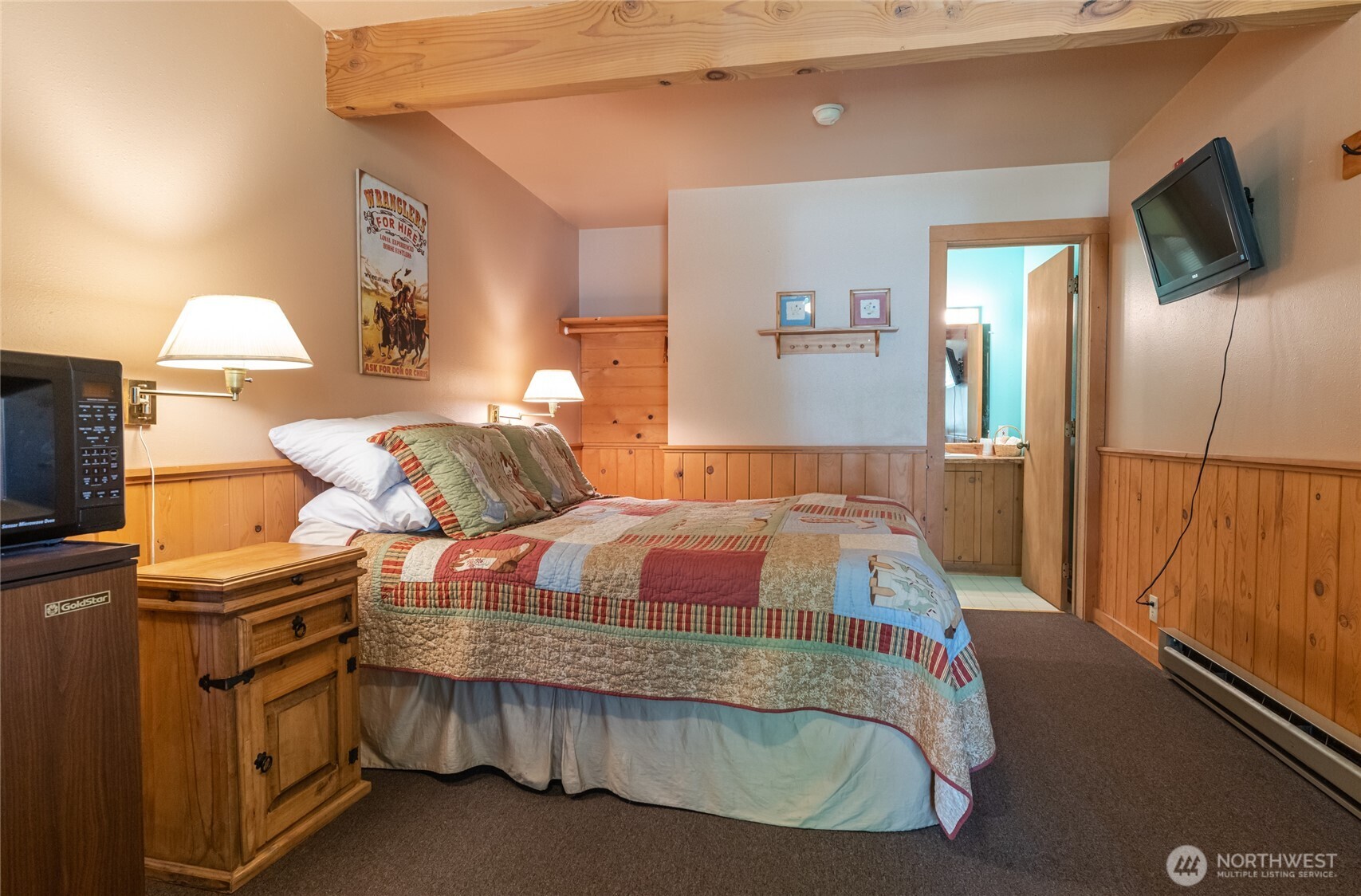 579 Eastside Chewuch Road Winthrop, WA 98862 - Photo 10 of 37 a bedroom with bed and flat screen tv