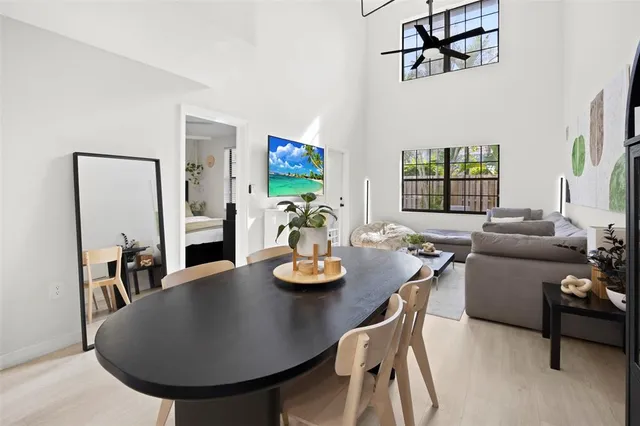 a living room with furniture and a dining table