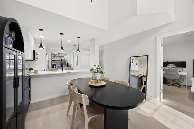 a dining room with furniture and wooden floor