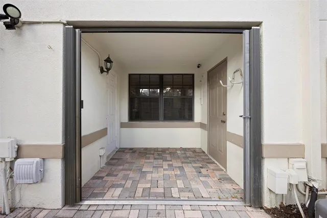 a view of a hallway view with wooden floor and a bathroom view