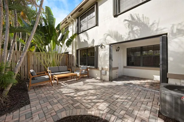a view of a bench in the backyard of the house