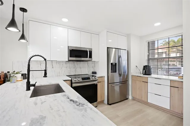 a kitchen with a refrigerator stove and microwave