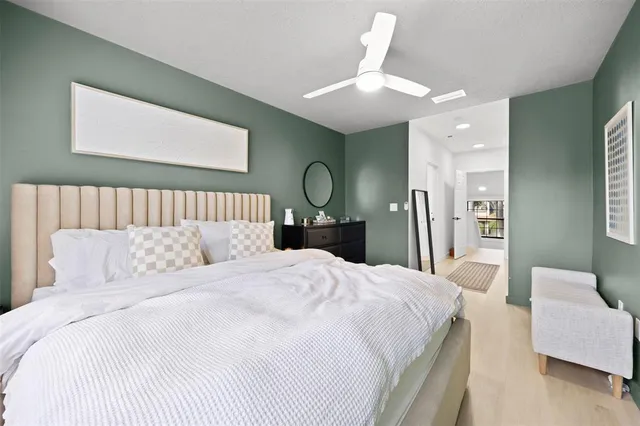 a bedroom with a bed and a chandelier