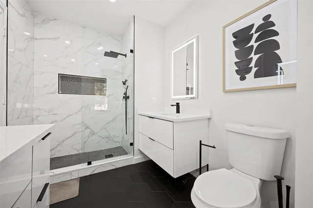 a bathroom with a sink a toilet and mirror