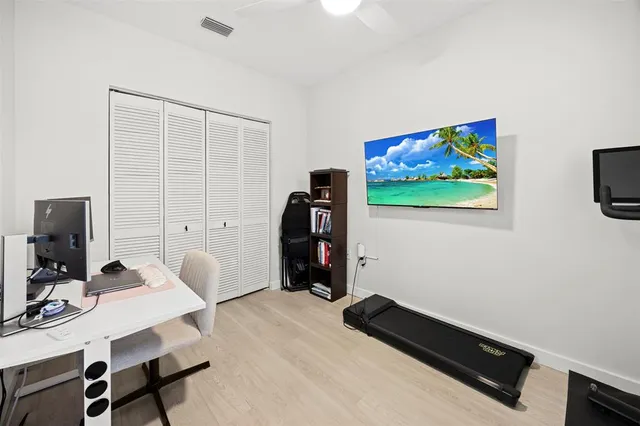 a view of a workspace with furniture and a bathroom