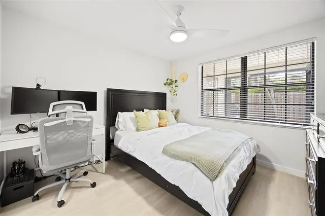 a bedroom with a bed and a large window