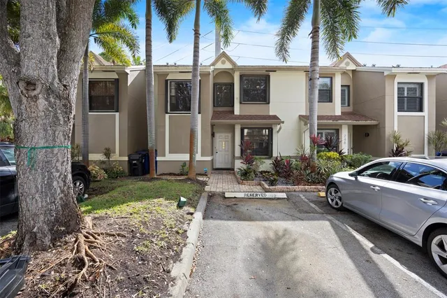 a view of a car parked in front of a brick house